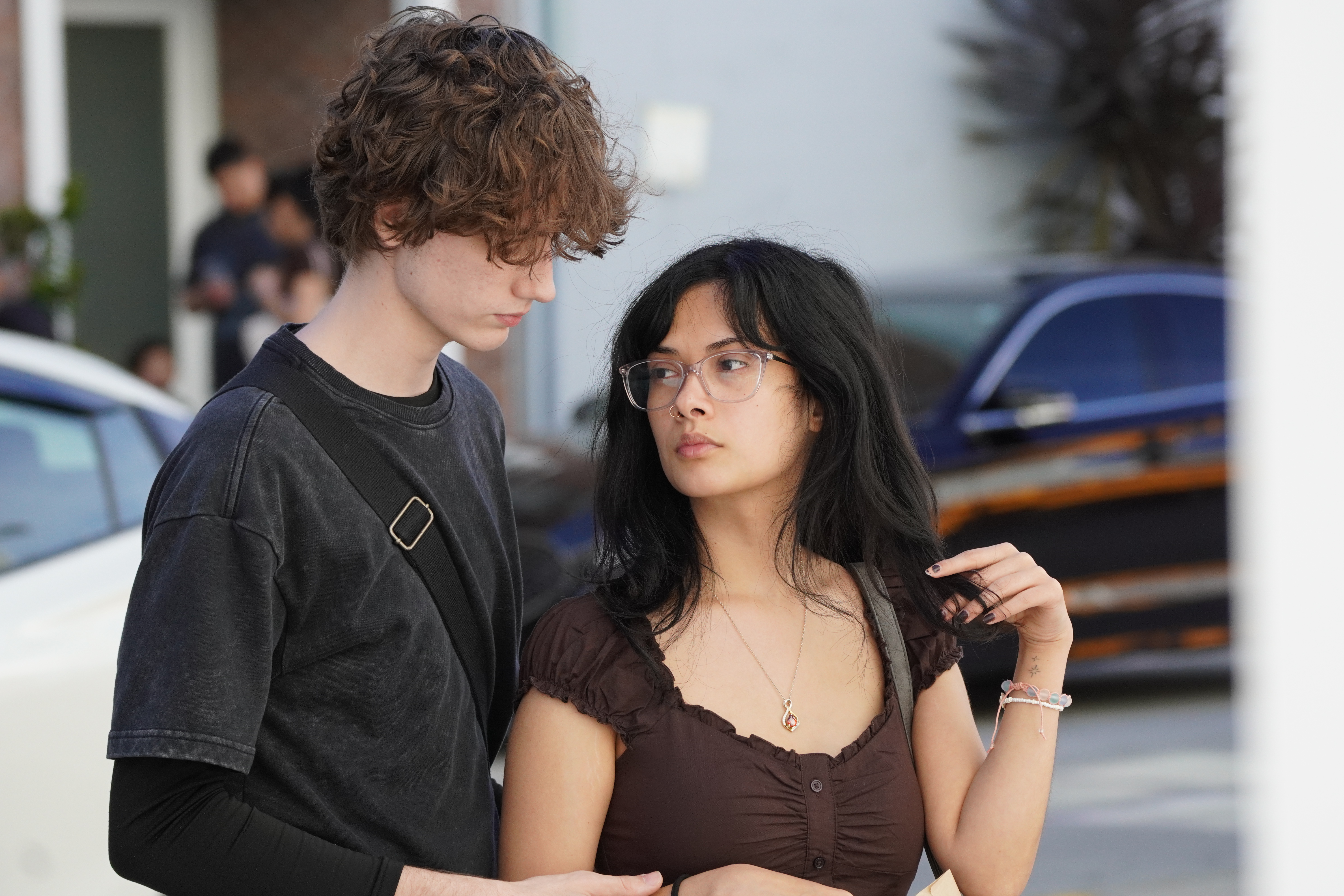Street portrait of two people standing close together outdoors