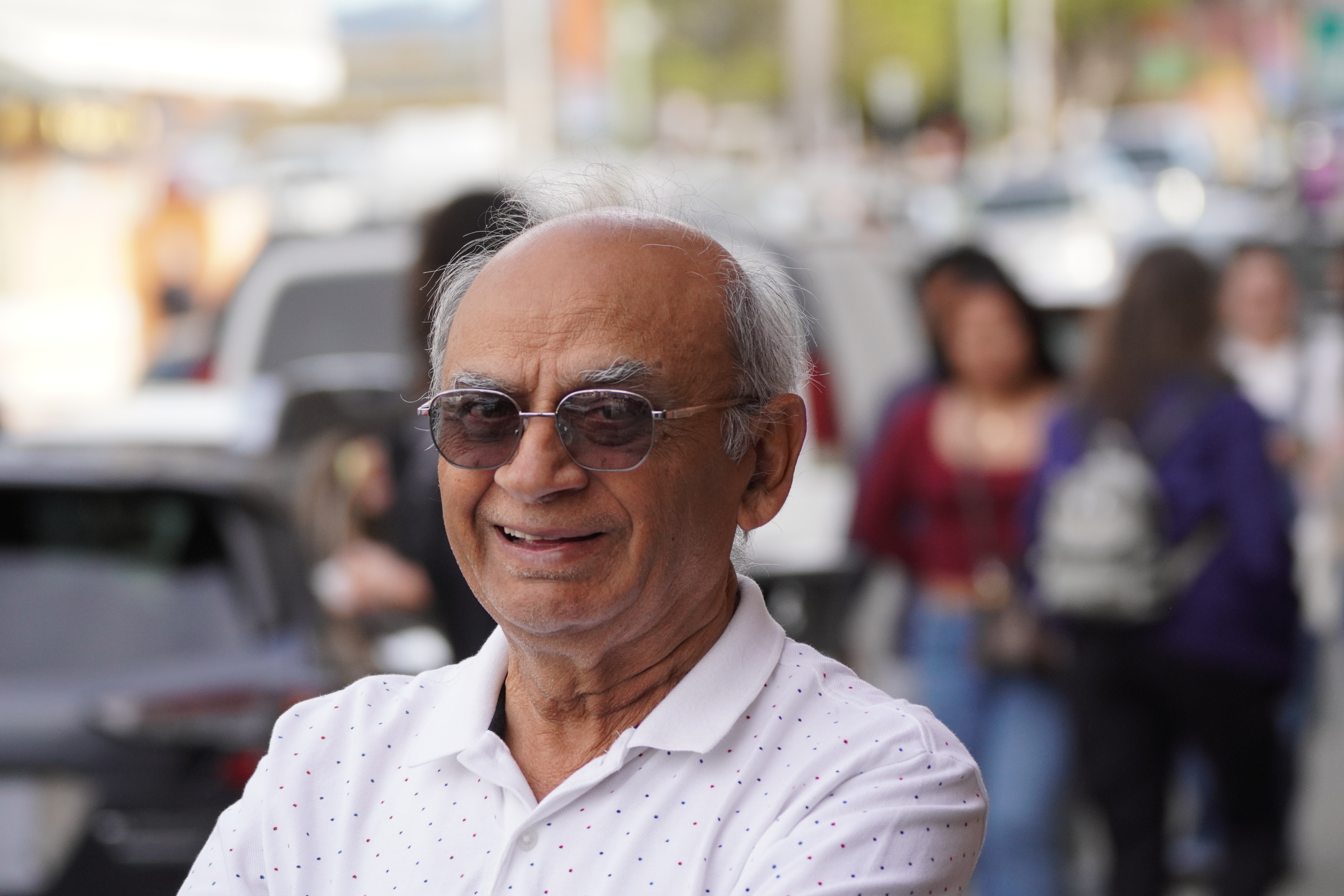 Portrait of an older man smiling on a city street